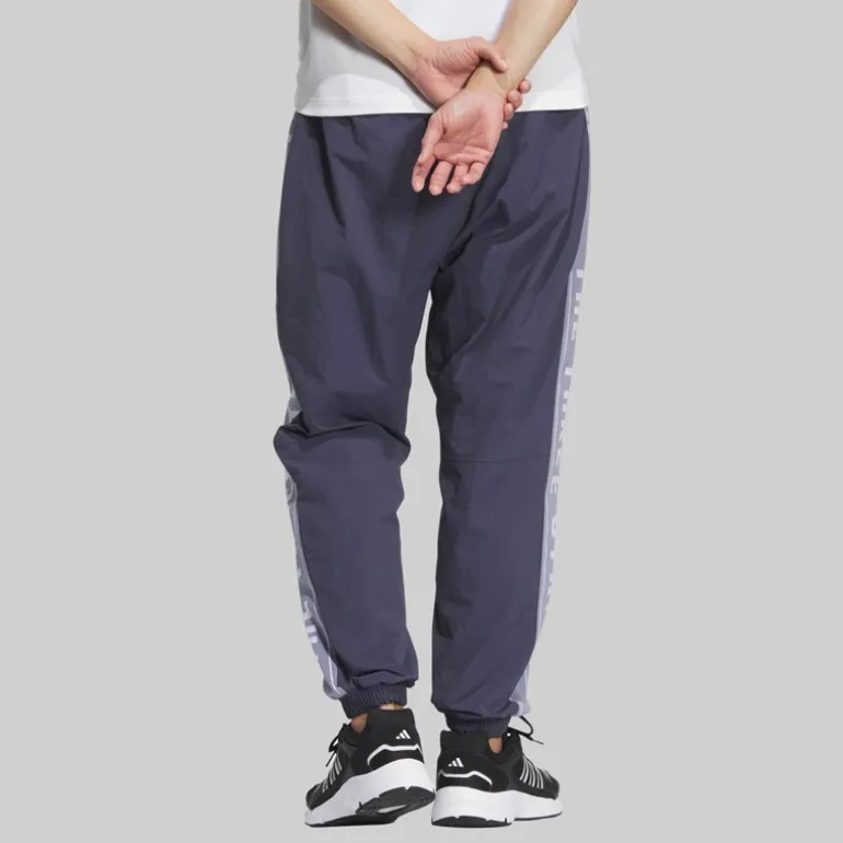 adidas Herren Schriftzug locker geschnittene gewebte Trainingshose Shadow Navy